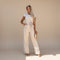 Yemelia beige flutter sleeve wide leg jumpsuit with adjustable waist tie and full-length silhouette.