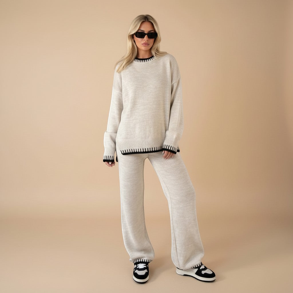 Yemelia beige knit sweater set with oversized top and wide leg pants, featuring contrast black trim detail. Soft knit fabric.