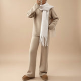 Yemelia beige knit lounge set with relaxed fit sweater and wide leg pants, featuring ribbed details and a white scarf.