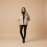 Yemelia oversized beige puffer jacket with faux fur trim and ribbed knit sleeves. Hooded design for warmth.
