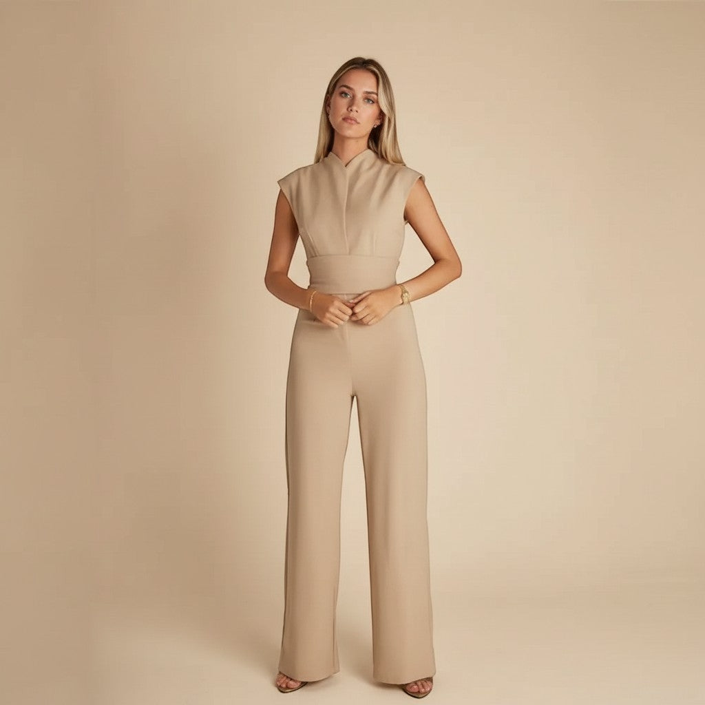 Yemelia sleeveless wide leg jumpsuit in beige with a cinched waist tie and elegant neckline.