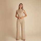 Yemelia sleeveless wide leg jumpsuit in beige with a cinched waist tie and elegant neckline.