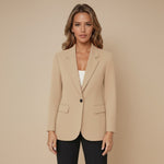 Yemelia beige tailored single button blazer with structured fit, classic lapels, and flap pockets. Smooth fabric, ideal for workwear.