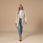 Yemelia beige tailored mid-length coat with button front, classic collar, and adjustable waist belt. Made from a structured fabric.