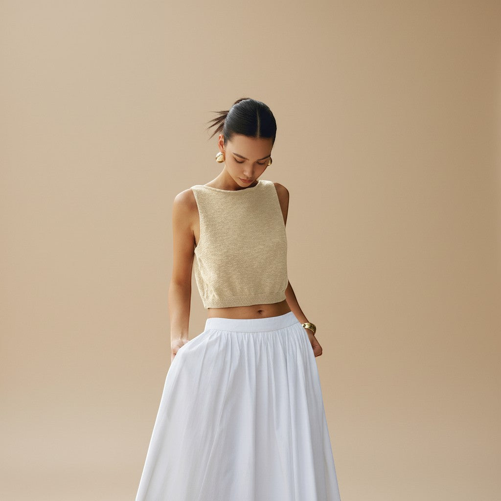 Yemelia beige sleeveless textured knit crop top with clean neckline and structured fit.