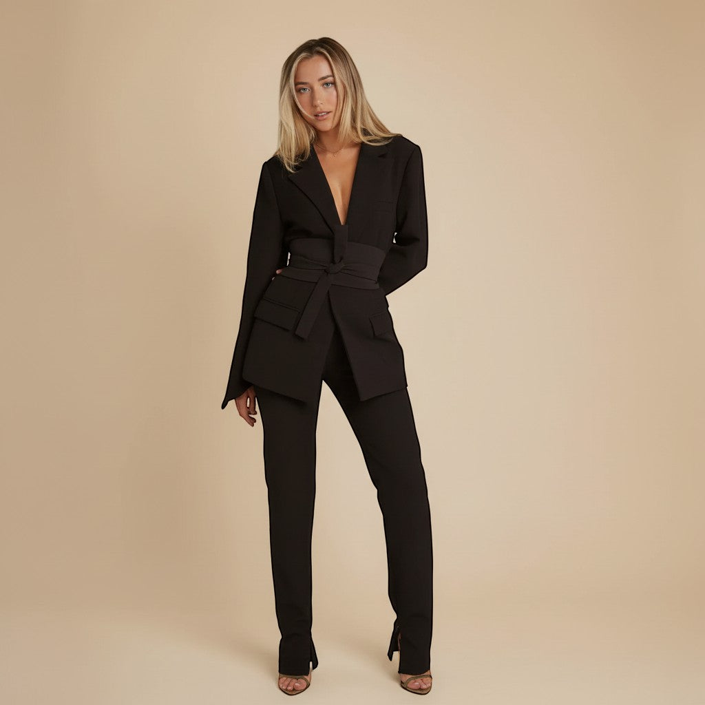 Yemelia black tailored blazer with relaxed fit, featuring a self-tie belt and classic lapels. Made from smooth, structured fabric.