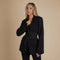 Yemelia black tailored blazer with relaxed fit, lapel neckline, and self-tie belt for waist definition. Made from smooth, structured fabric.