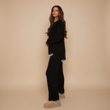 Yemelia black knit lounge set with crew neck sweater and relaxed pants featuring contrast trim detail. Soft fabric.