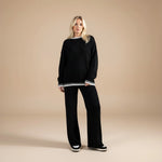 Yemelia black knit set with oversized sweater and wide leg pants, featuring contrast trim detail. Soft, cozy fabric for loungewear or casual wear.