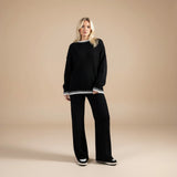 Yemelia black knit set with oversized sweater and wide leg pants, featuring contrast trim detail. Soft, cozy fabric for loungewear or casual wear.