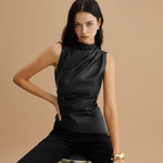 Yemelia black sleeveless draped faux leather top with high neck and fitted silhouette.