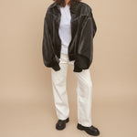 Yemelia black faux leather bomber jacket with white contrast stitching, zip front, and ribbed trim. Ideal for casual wear.