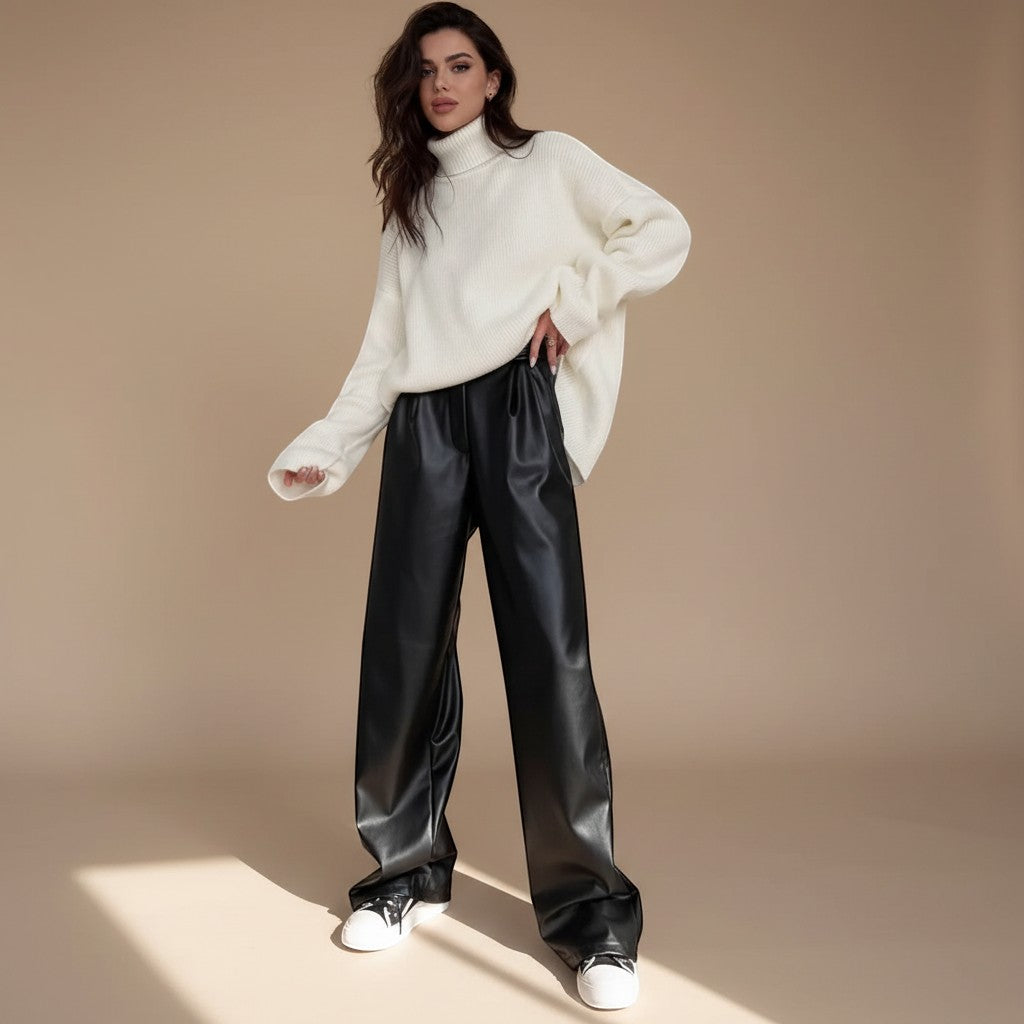 Yemelia black faux leather high waist wide leg pants with belt and side pockets.