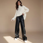 Yemelia black faux leather high waist wide leg pants with belt and side pockets.