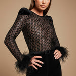 Yemelia black lace jumpsuit with feather cuffs, structured shoulders, and sequin detail. Full length.
