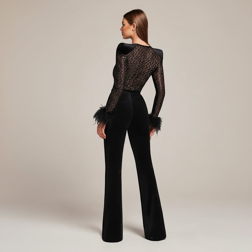 Yemelia black lace jumpsuit with feather cuffs, structured shoulders, and flared legs. Elegant evening wear.