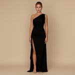 Yemelia black one shoulder draped evening gown with high slit and sculpted fit. Floor-length formal dress.
