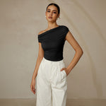 Yemelia black one shoulder ruched fitted top with asymmetrical neckline and stretch fabric.
