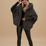 Yemelia black oversized hooded puffer jacket with textured finish and ribbed cuffs.