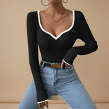 Yemelia black ribbed long sleeve top with contrast trim V neckline and fitted silhouette.
