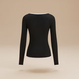Yemelia black ribbed long sleeve top with contrast trim V-neck and hem. Soft, stretchy fabric.