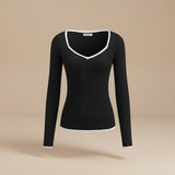 Yemelia black ribbed long sleeve top with contrast trim V-neck and cuffs. Soft, stretchy fabric.