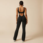 Yemelia black sleeveless sculpting flared leg jumpsuit with ruched detail on the back.