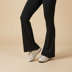 Yemelia black sleeveless sculpting flared leg jumpsuit made of smooth, stretch fabric.