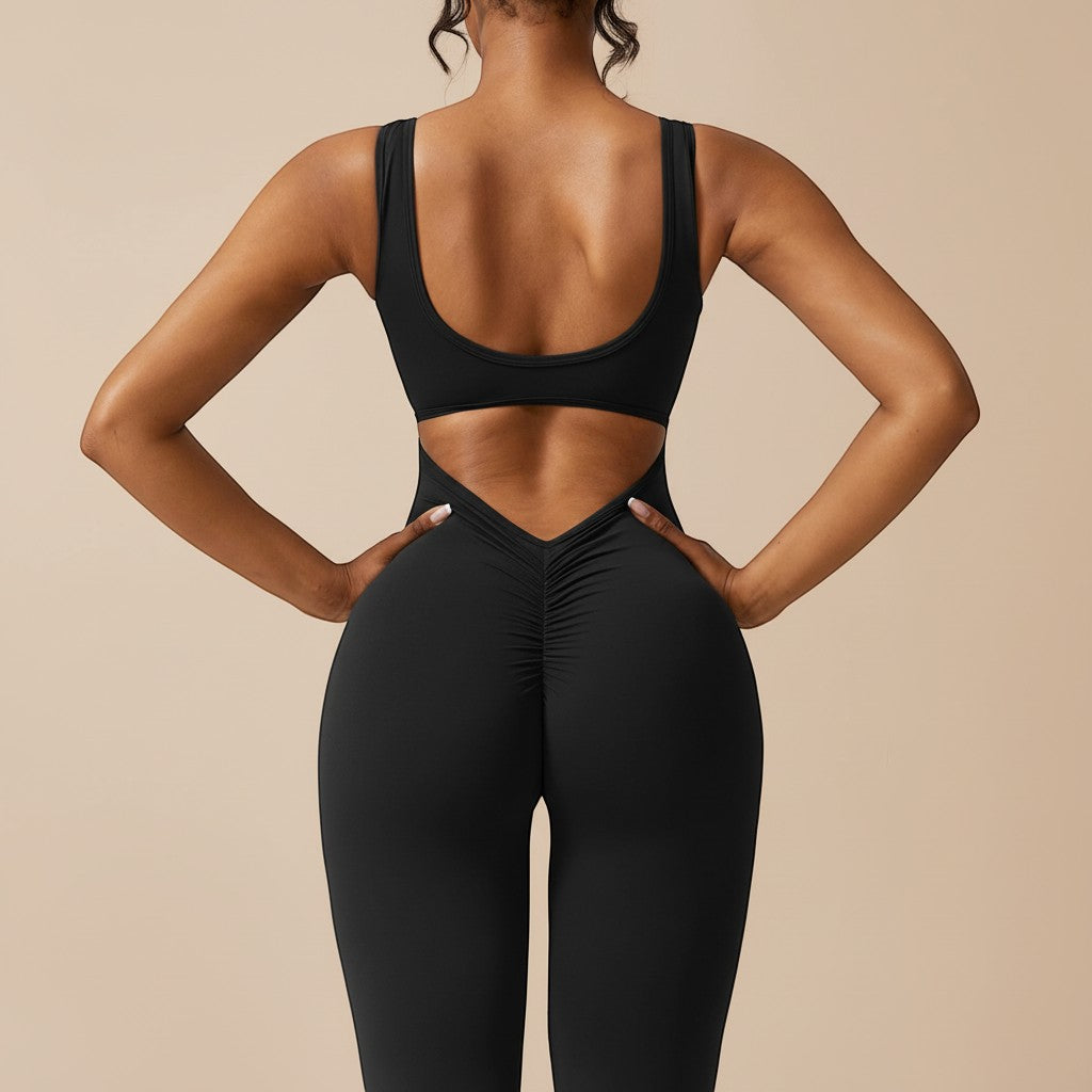 Yemelia black sleeveless sculpting jumpsuit with ruched back and flared legs, made from smooth stretch fabric.