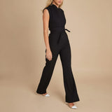 Yemelia black sleeveless wide leg jumpsuit with a tie waist and high neckline. Elegant and tailored for formal events or workwear.