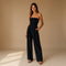 Yemelia black strapless wide leg jumpsuit with tailored fit and side pockets. Elegant evening wear.