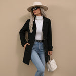 Yemelia black tailored mid-length coat with button front, classic collar, and waist belt. Structured silhouette.