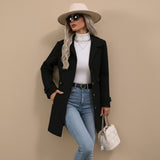 Yemelia black tailored mid-length coat with button front, classic collar, and waist belt. Structured silhouette.