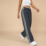 Yemelia black high waist wide leg track pants with white side stripe detail and elastic waistband.