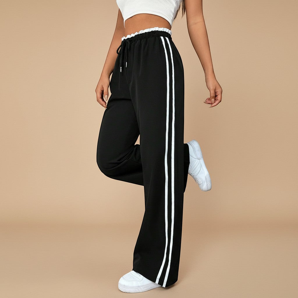 Yemelia black high waist wide leg track pants with white side stripes and drawstring waist. Lightweight fabric.