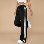 Yemelia black high waist wide leg track pants with white side stripes and drawstring waist. Lightweight fabric.