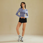 Yemelia light blue long sleeve fitted crop top with thumbhole cuffs made of soft, stretchy fabric.