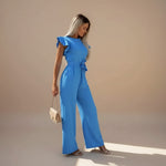 Yemelia blue flutter sleeve wide leg jumpsuit with adjustable waist tie and full-length silhouette.