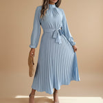 Yemelia light blue long sleeve pleated midi dress with high neck and waist tie. Elegant, flowing silhouette for events.