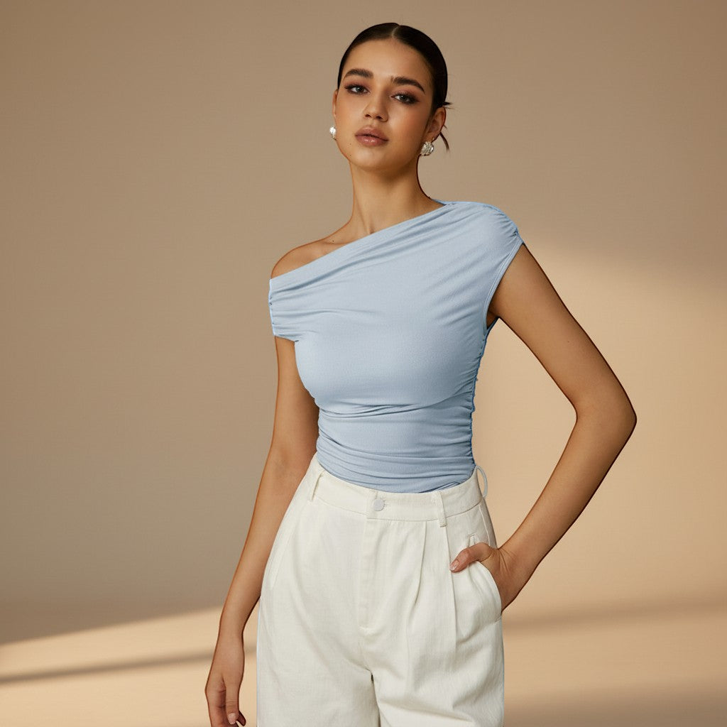 Yemelia light blue ruched one-shoulder fitted top with asymmetrical neckline and stretch fabric.