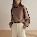 Yemelia brown knit turtleneck sweater with black contrast trim detailing on shoulders and sleeves. Ribbed cuffs and hem.