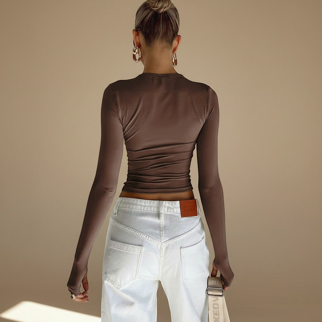 Yemelia long sleeve fitted brown top with thumbhole detail and minimalist neckline, made from stretch fabric.