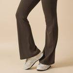 Yemelia sleeveless brown sculpting flared leg jumpsuit made of smooth, stretch fabric.