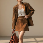 Yemelia brown suede relaxed fit button front blazer with notched lapels and flap pockets.