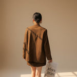 Yemelia brown suede relaxed fit button front blazer with notched lapel and flap pockets.