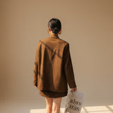 Yemelia brown suede relaxed fit button front blazer with notched lapel and flap pockets.