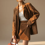 Yemelia brown suede relaxed fit button front blazer with notched lapels and flap pockets.