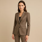 Yemelia brown tailored single-button blazer with notched lapels and flap pockets, made from smooth structured fabric.