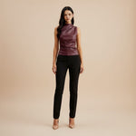 Yemelia sleeveless draped faux leather top in deep burgundy with a high neckline and flattering fit.
