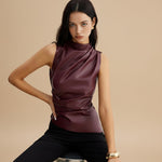 Yemelia sleeveless draped faux leather top in deep burgundy with a high neckline and fitted silhouette.